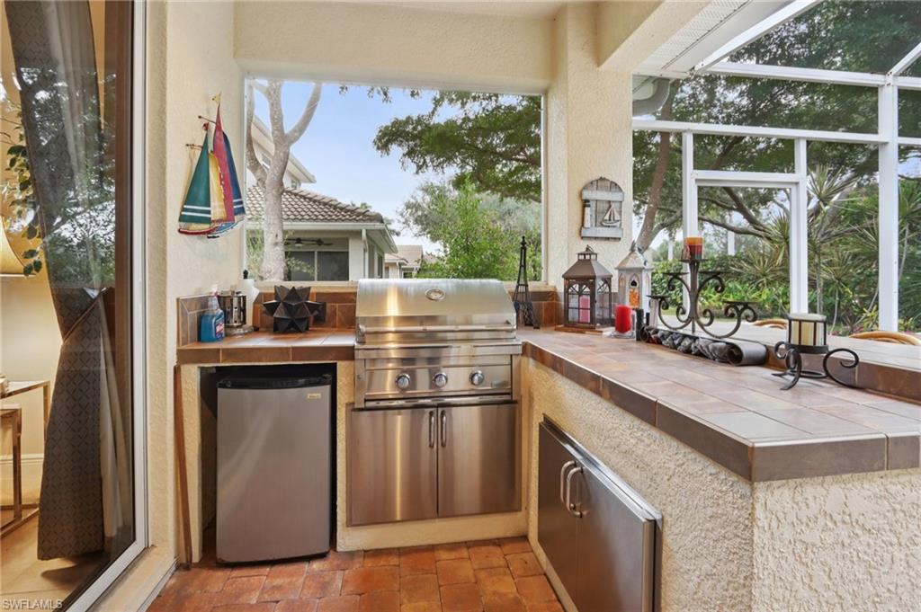 19612 Tesoro Way Estero, FL 33967 - Photo 30 of 50 a kitchen with stainless steel appliances granite countertop a refrigerator and a sink