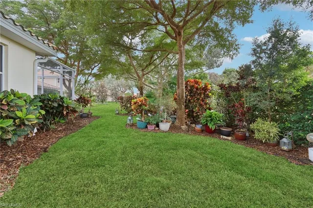 a front view of a house with a garden and yard