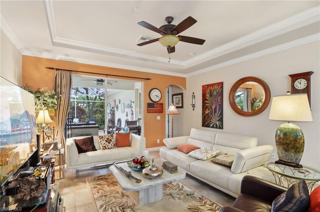 19612 Tesoro Way Estero, FL 33967 - Photo 7 of 50 a living room with furniture a clock and a large window