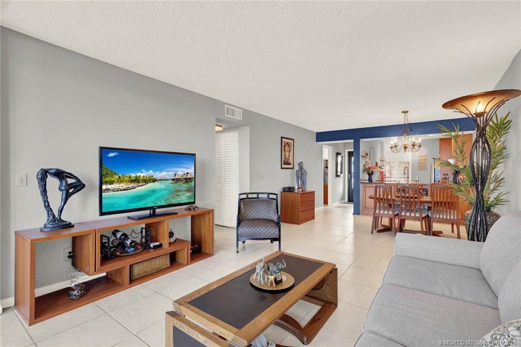 1950 Southwest Palm City Road, Unit 8106 Stuart, FL 34994 - Photo 24 of 54 a living room with furniture and a flat screen tv