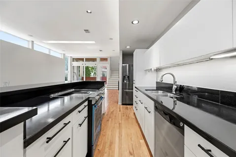 a kitchen with granite countertop a sink and cabinets