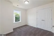an empty room with windows and closet