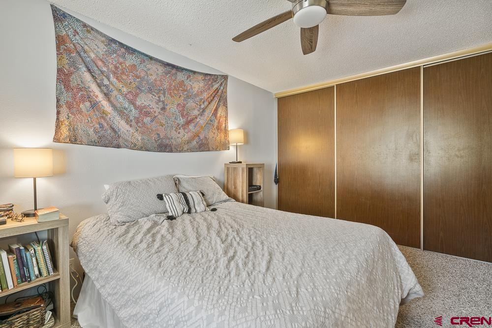 34237 Highway 550, Unit 18 Durango, CO 81301 - Photo 15 of 21 a bedroom with a bed and a book shelf