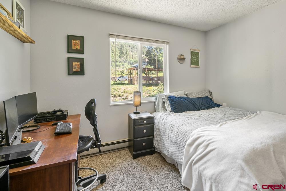 34237 Highway 550, Unit 18 Durango, CO 81301 - Photo 16 of 21 a bedroom with a bed and a desk