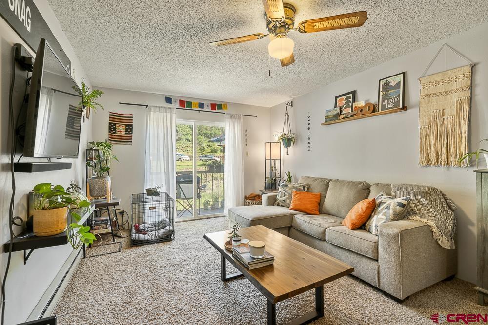 34237 Highway 550, Unit 18 Durango, CO 81301 - Photo 4 of 21 a living room with furniture and a flat screen tv