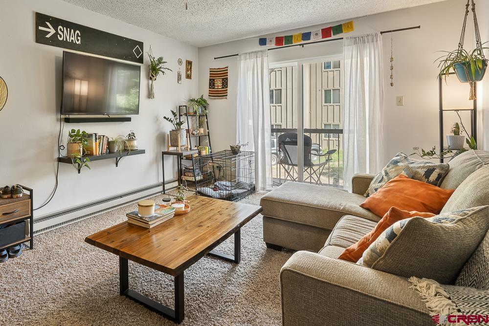 34237 Highway 550, Unit 18 Durango, CO 81301 - Photo 7 of 21 a living room with furniture and a flat screen tv