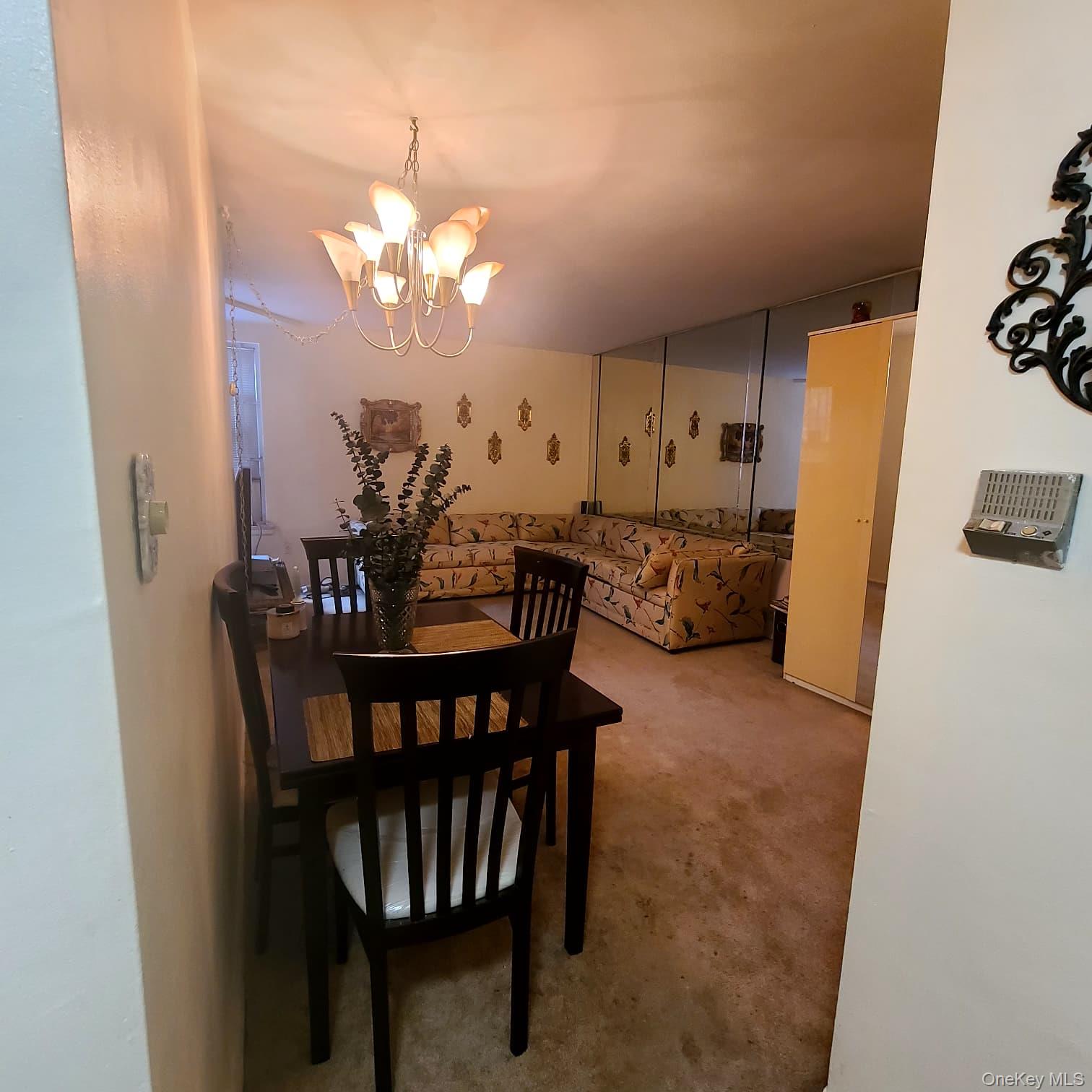 83-25 98th Street, Unit 2T Queens, NY 11421 - Photo 4 of 6 a view of a dining room with furniture and chandelier