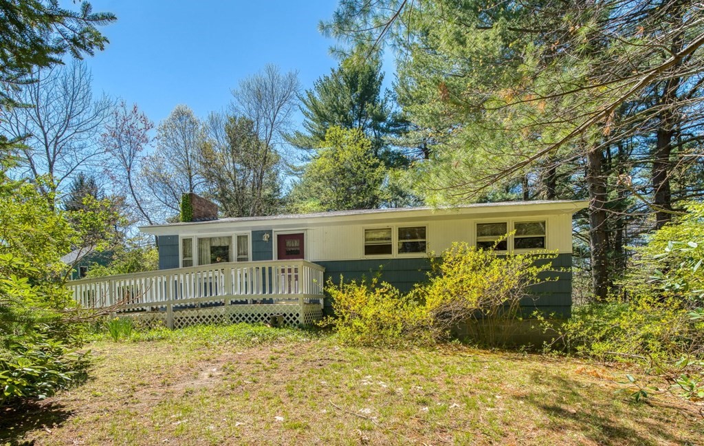 11 Flavell Road Groton, MA 01450 - Photo 1 of 26 a backyard of a house with yard and outdoor seating