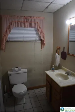 a bathroom with a toilet sink and mirror