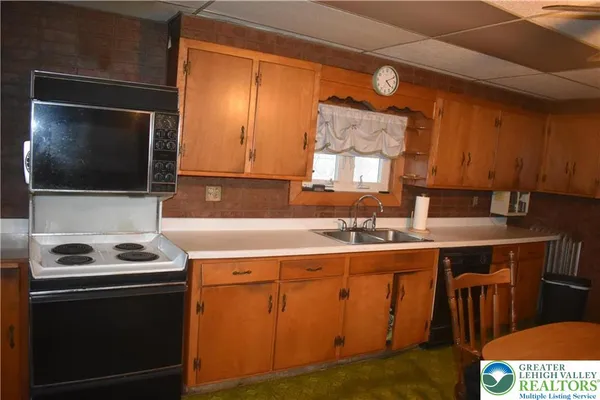 a kitchen with a sink a stove and cabinets