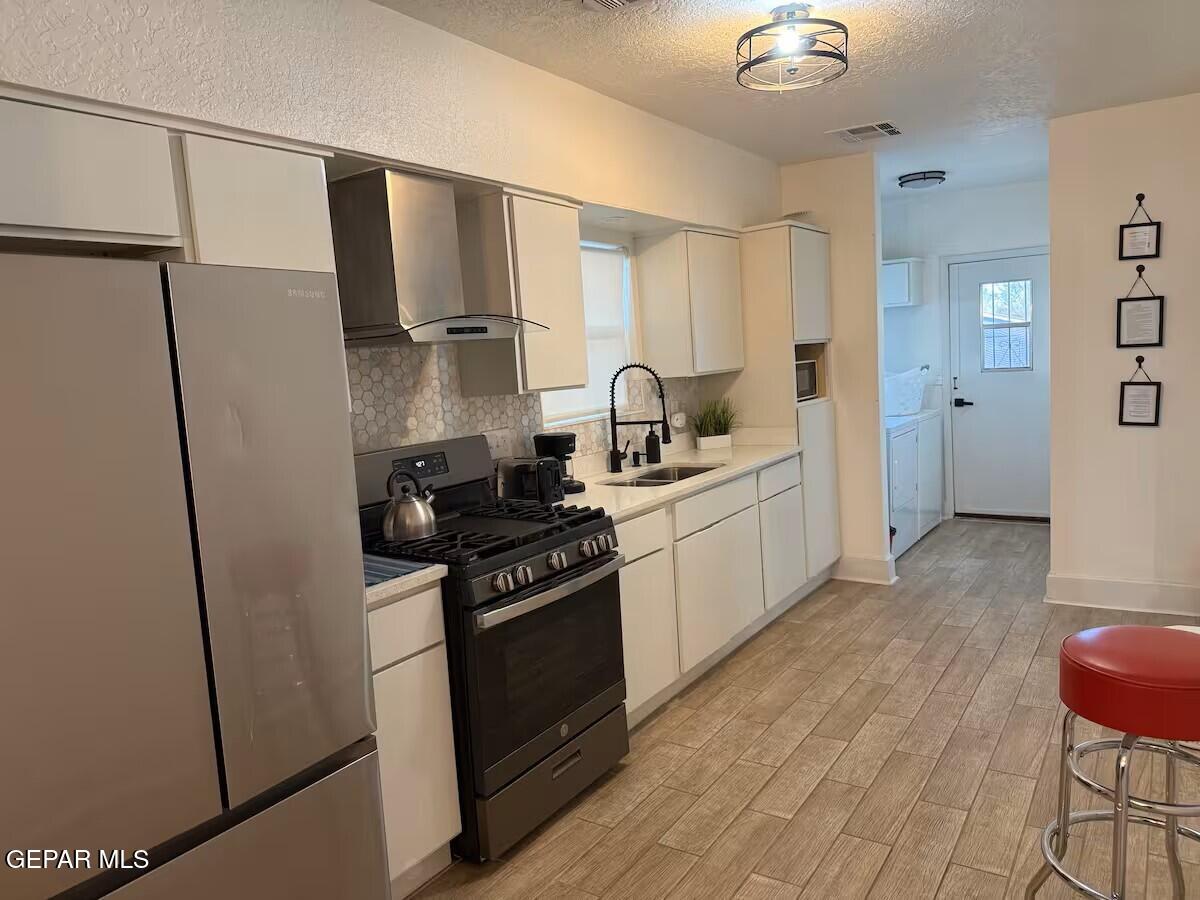 4012 Trowbridge Drive, Unit A FURNISHED El Paso, TX 79903 - Photo 13 of 53 a kitchen with stainless steel appliances a sink a stove a refrigerator and cabinets