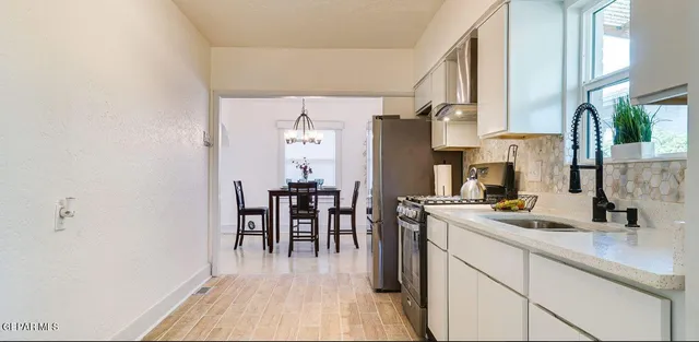 a stove top oven sitting inside of a kitchen