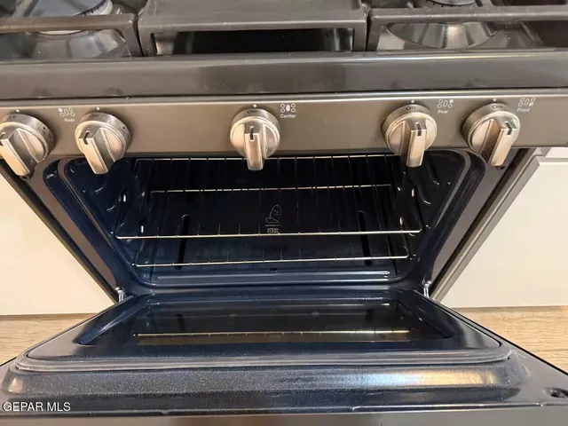 a kitchen with a sink and a stove with granite countertop