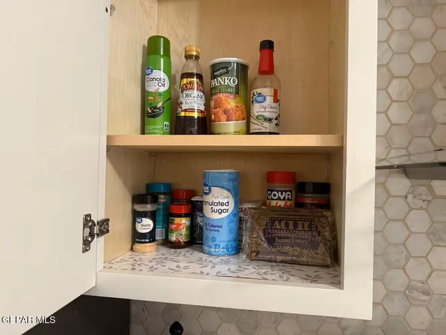 a view of a kitchen with fridge and wooden floor