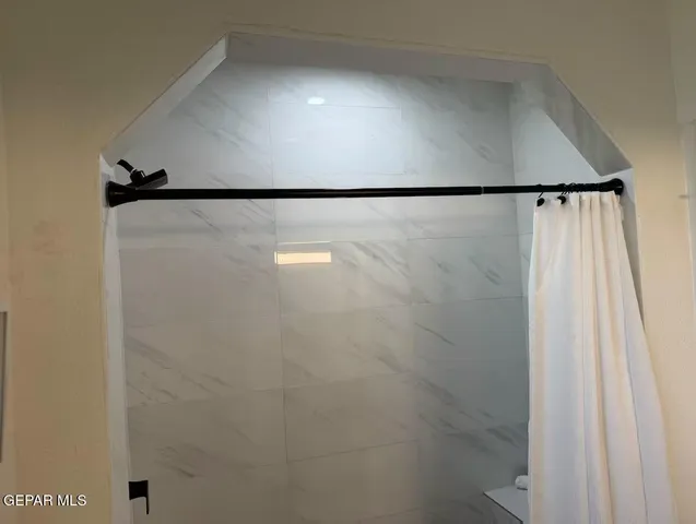 a bedroom with a bed with window