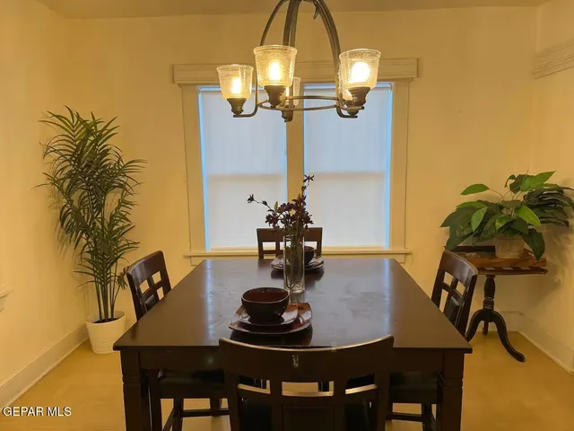 a dining room with furniture and wooden floor