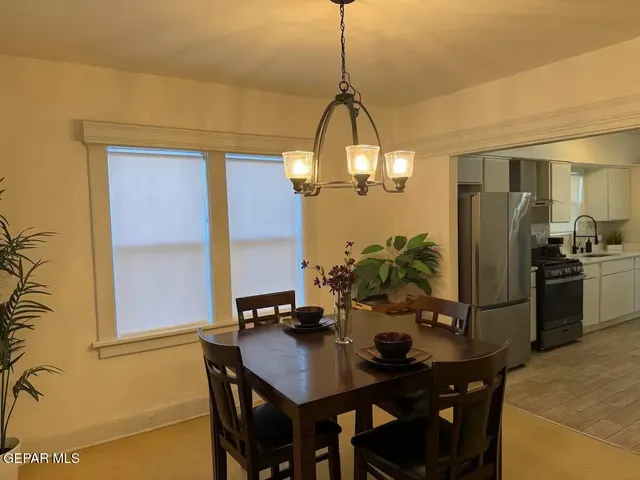 a view of a dining room with furniture and chandelier