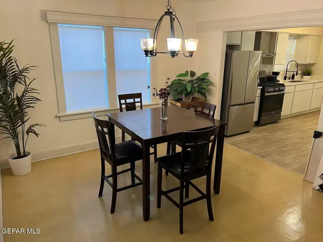 a dining room with furniture and chandelier