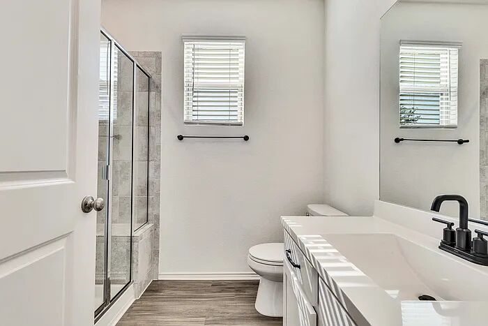 10403 Bramble Berry Drive Austin, TX 78748 - Photo 13 of 21 a bathroom with a sink a toilet and shower