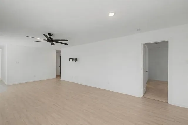 a view of a room with a ceiling fan