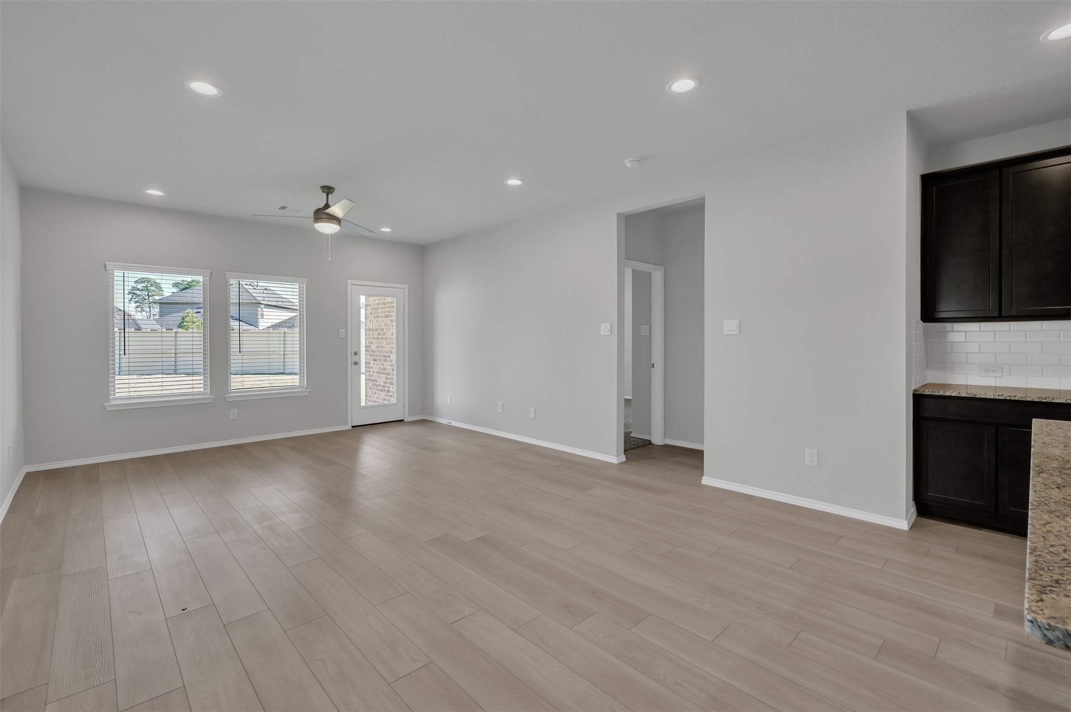 17105 Upland Bent Court Conroe, TX 77385 - Photo 12 of 40 a view of an empty room with a window and fireplace