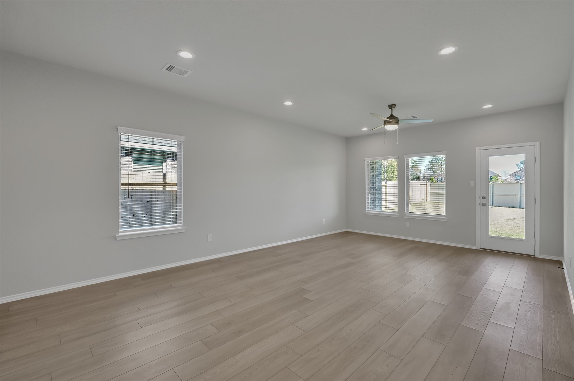 17105 Upland Bent Court Conroe, TX 77385 - Photo 13 of 40 a view of an empty room with wooden floor and a window