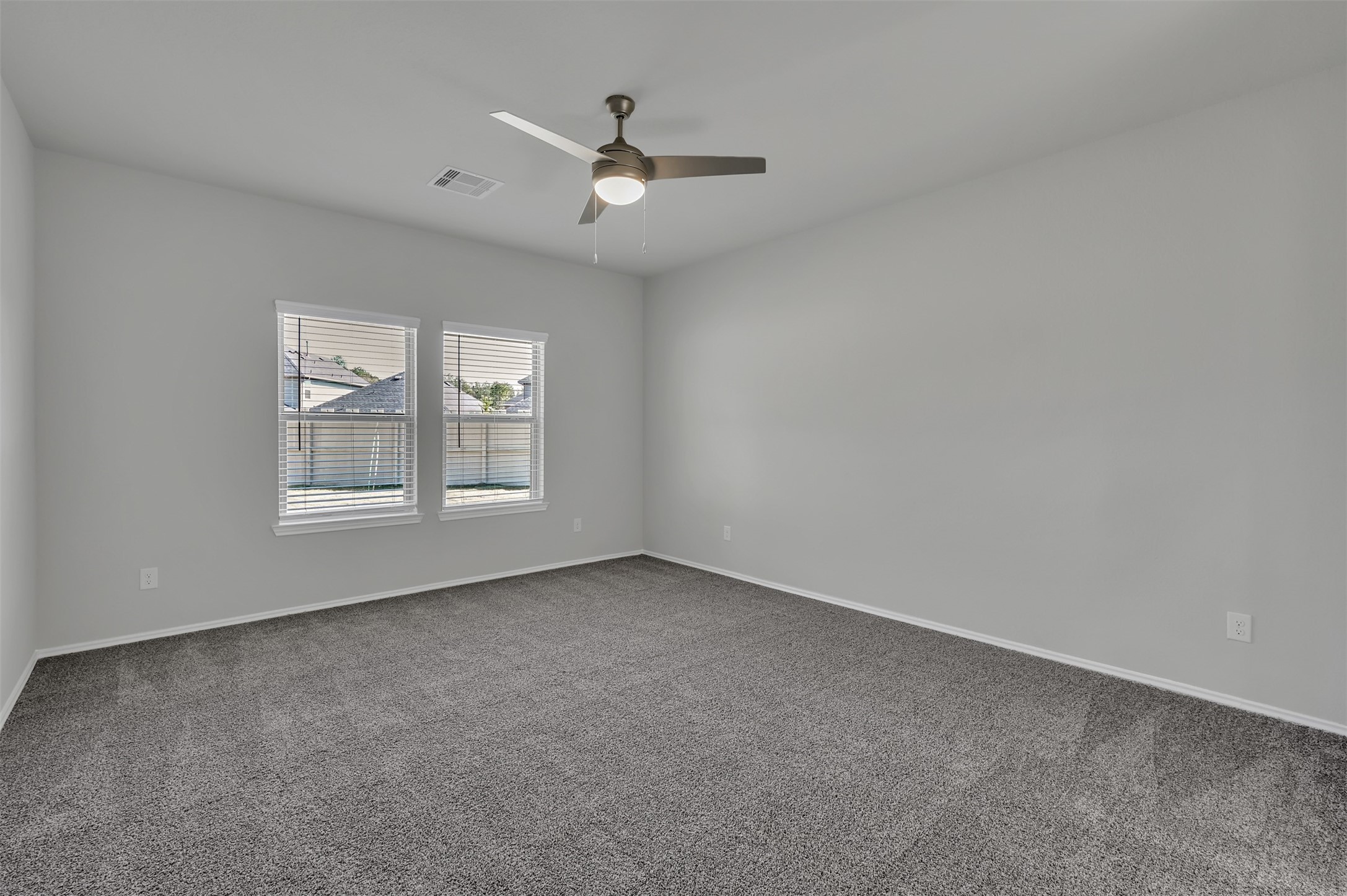 17105 Upland Bent Court Conroe, TX 77385 - Photo 17 of 40 an empty room with windows and ceiling fan view