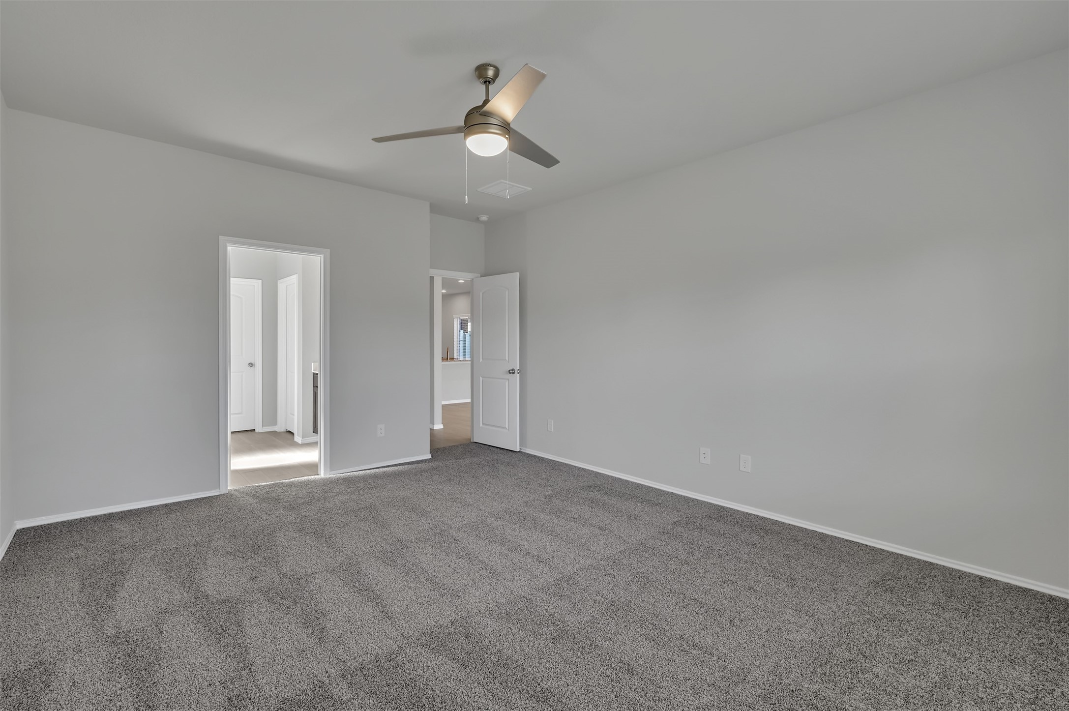 17105 Upland Bent Court Conroe, TX 77385 - Photo 18 of 40 a view of an empty room with a chandelier fan