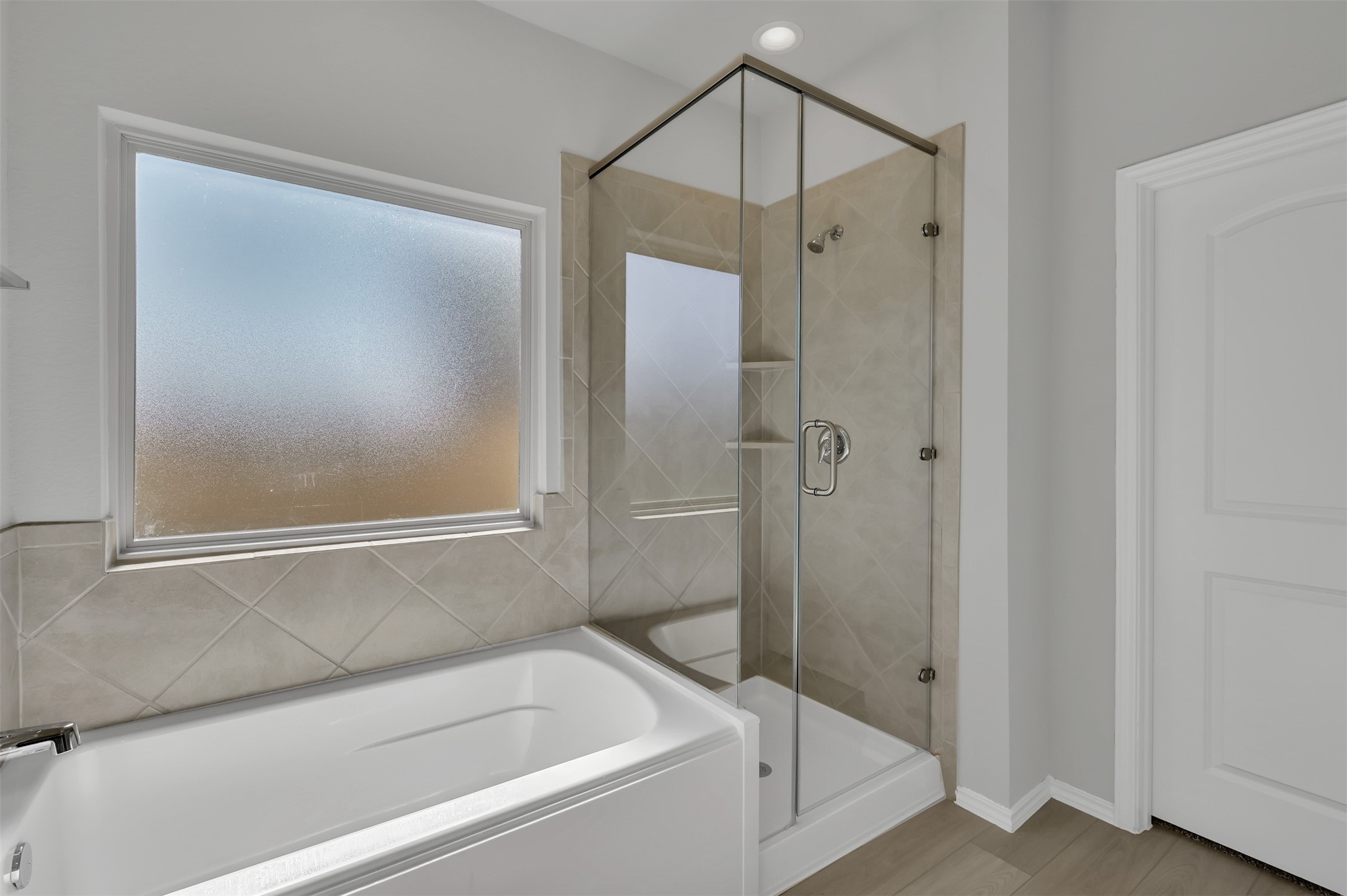 17105 Upland Bent Court Conroe, TX 77385 - Photo 22 of 40 a bathroom with a bathtub and a shower