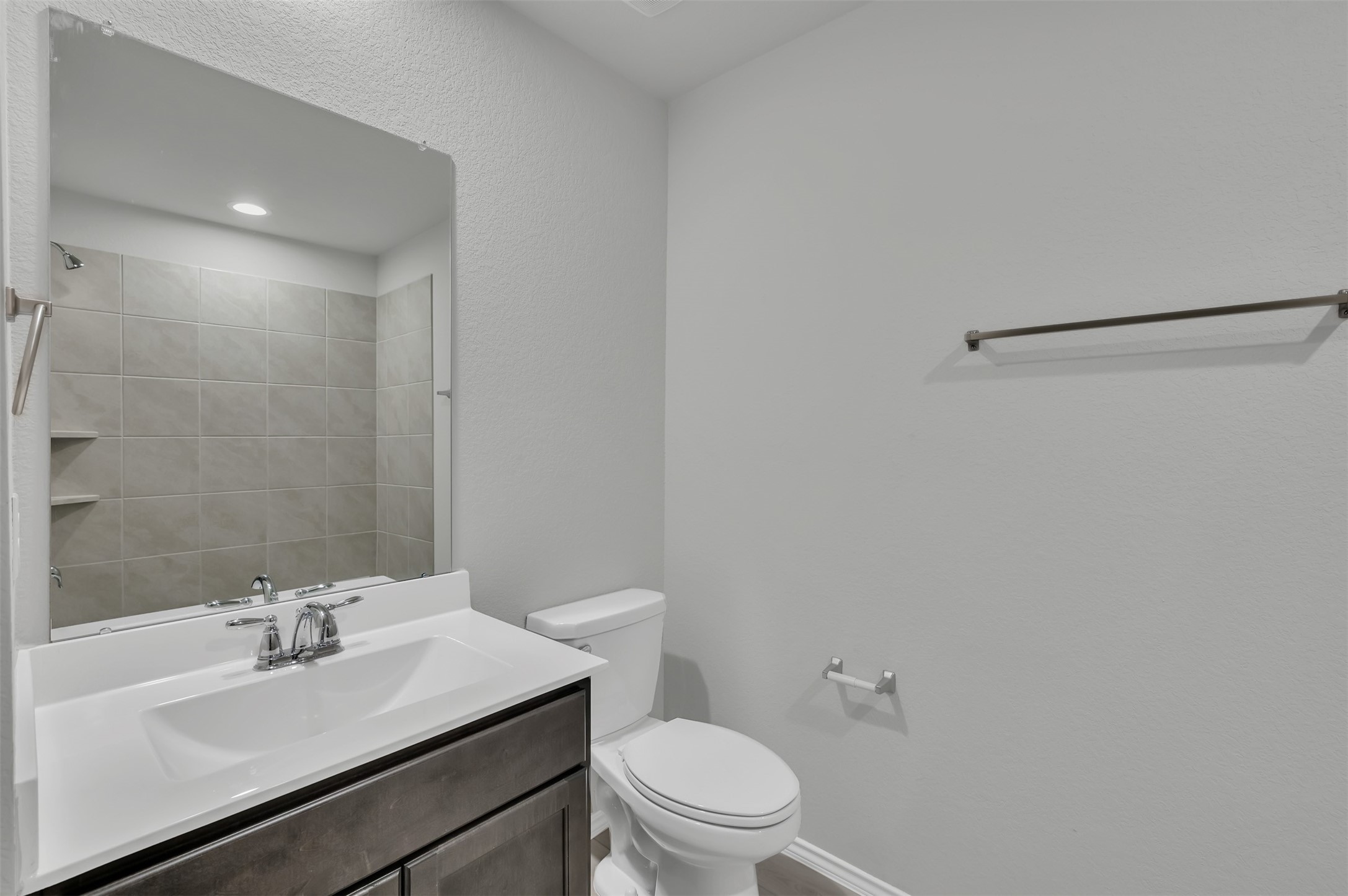 17105 Upland Bent Court Conroe, TX 77385 - Photo 30 of 40 a bathroom with a sink vanity mirror and toilet