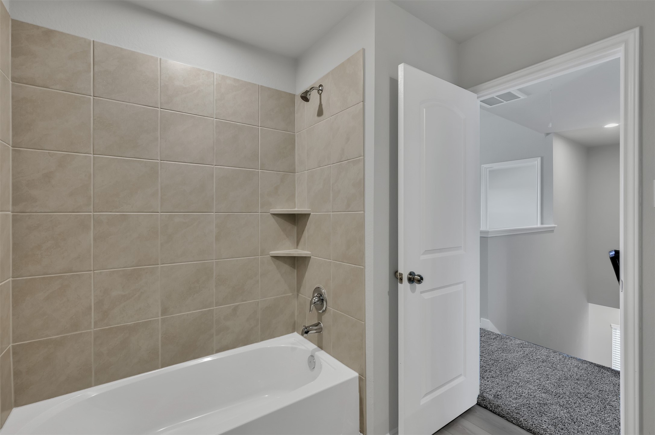 17105 Upland Bent Court Conroe, TX 77385 - Photo 31 of 40 a bathroom with a bathtub and a shower