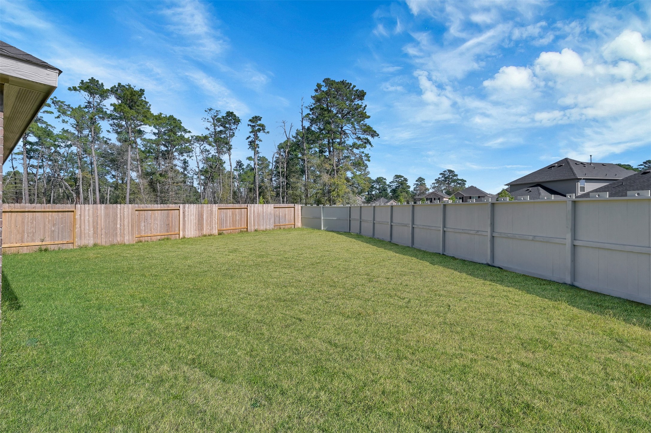 17105 Upland Bent Court Conroe, TX 77385 - Photo 36 of 40 a view of a backyard with grass and fence