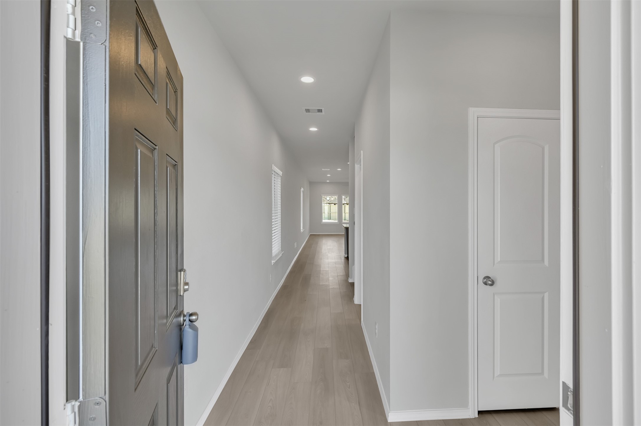 17105 Upland Bent Court Conroe, TX 77385 - Photo 5 of 40 a view of a hallway with wooden floor