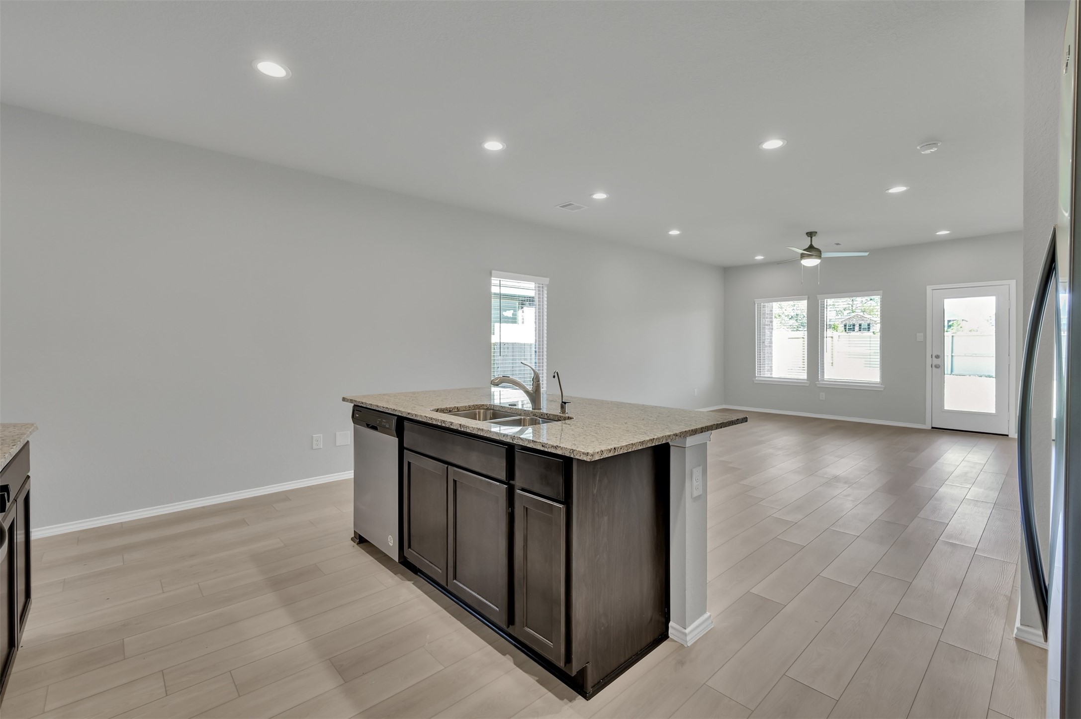 17105 Upland Bent Court Conroe, TX 77385 - Photo 9 of 40 a kitchen with a sink and chandelier