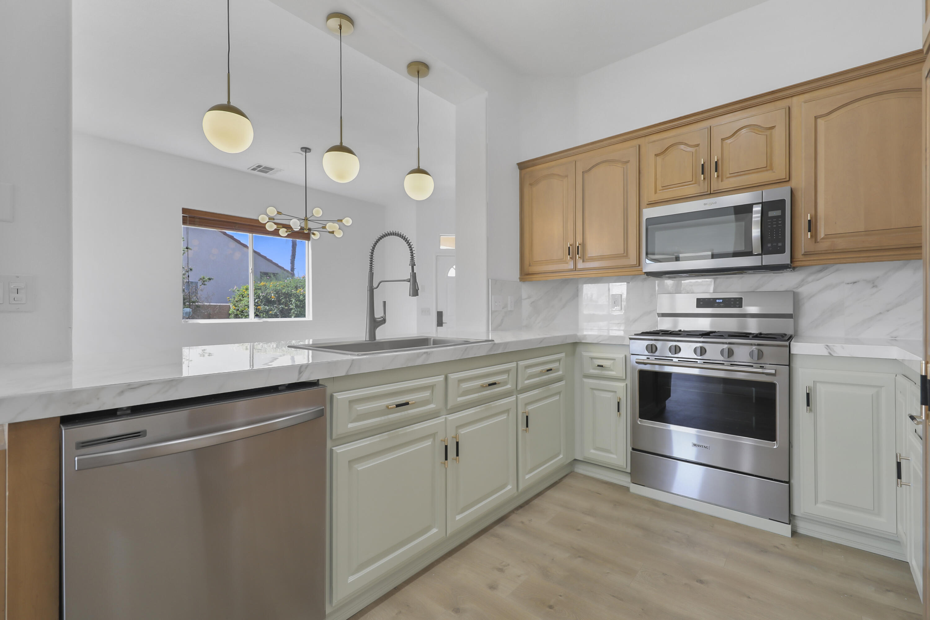 68256 Pasada Road Cathedral City, CA 92234 - Photo 13 of 35 a kitchen with granite countertop a sink stainless steel appliances and cabinets