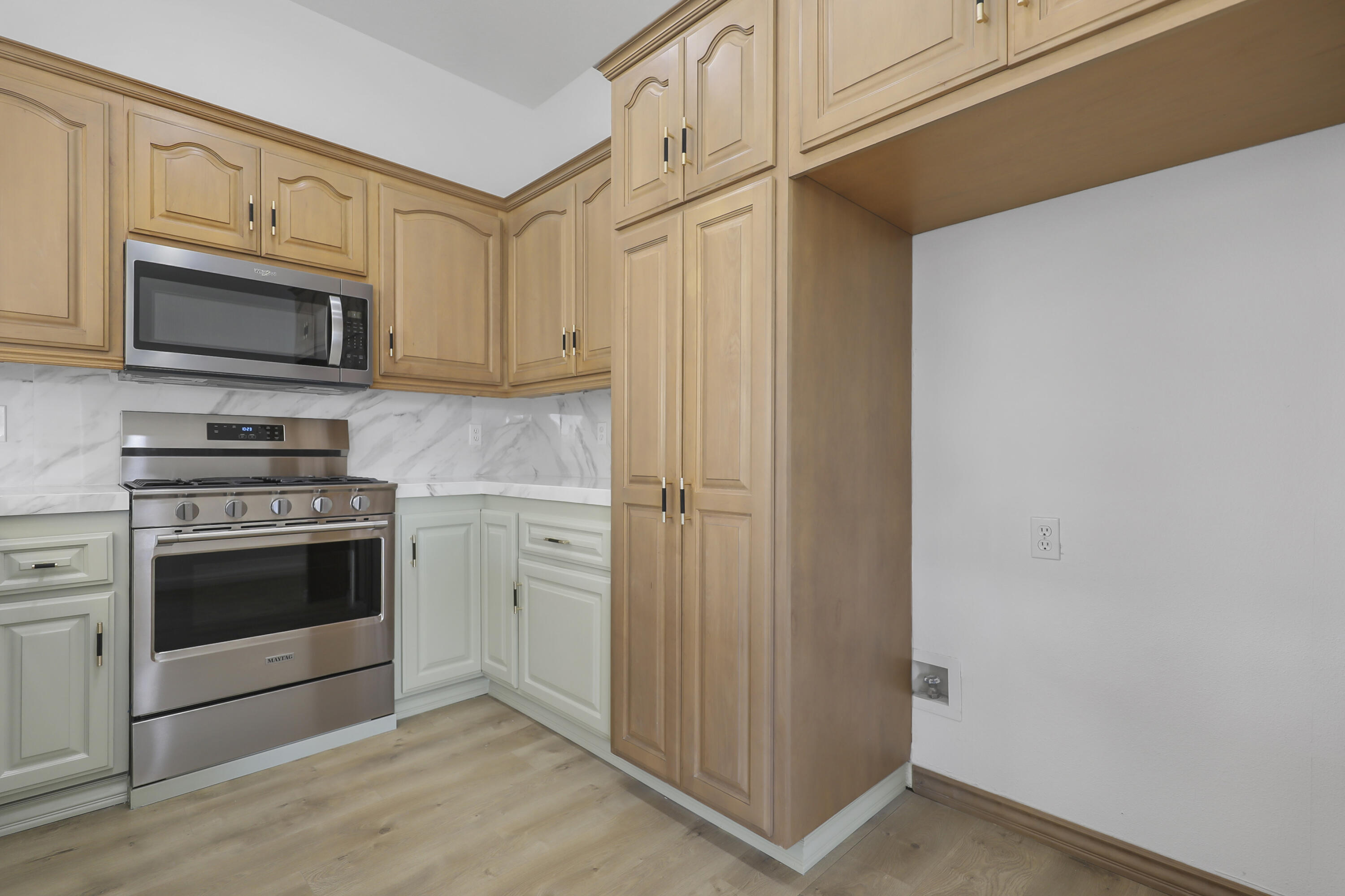 68256 Pasada Road Cathedral City, CA 92234 - Photo 14 of 35 a kitchen with stainless steel appliances white cabinets and a stove top oven