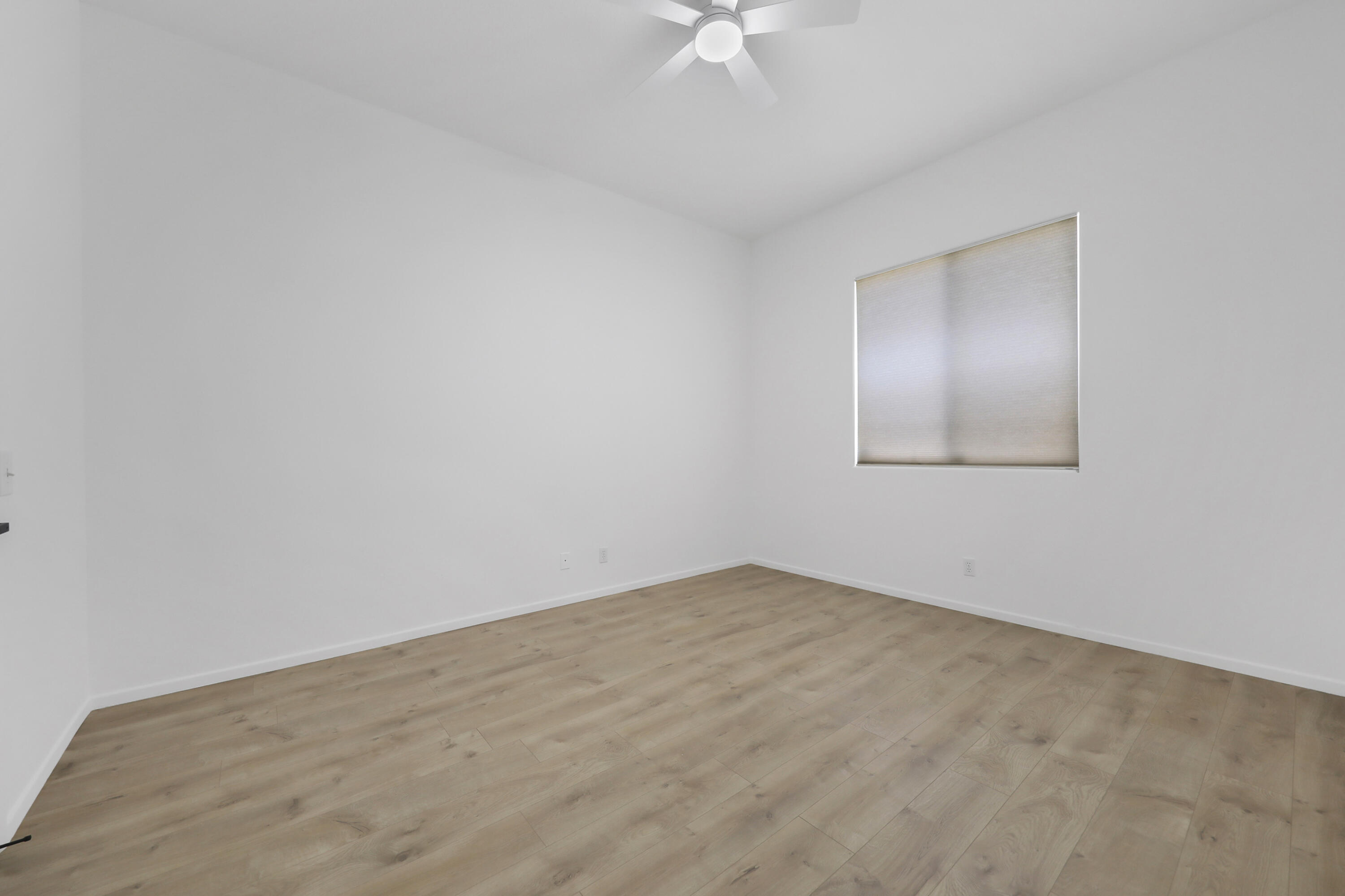 68256 Pasada Road Cathedral City, CA 92234 - Photo 20 of 35 an empty room with a chandelier fan and windows