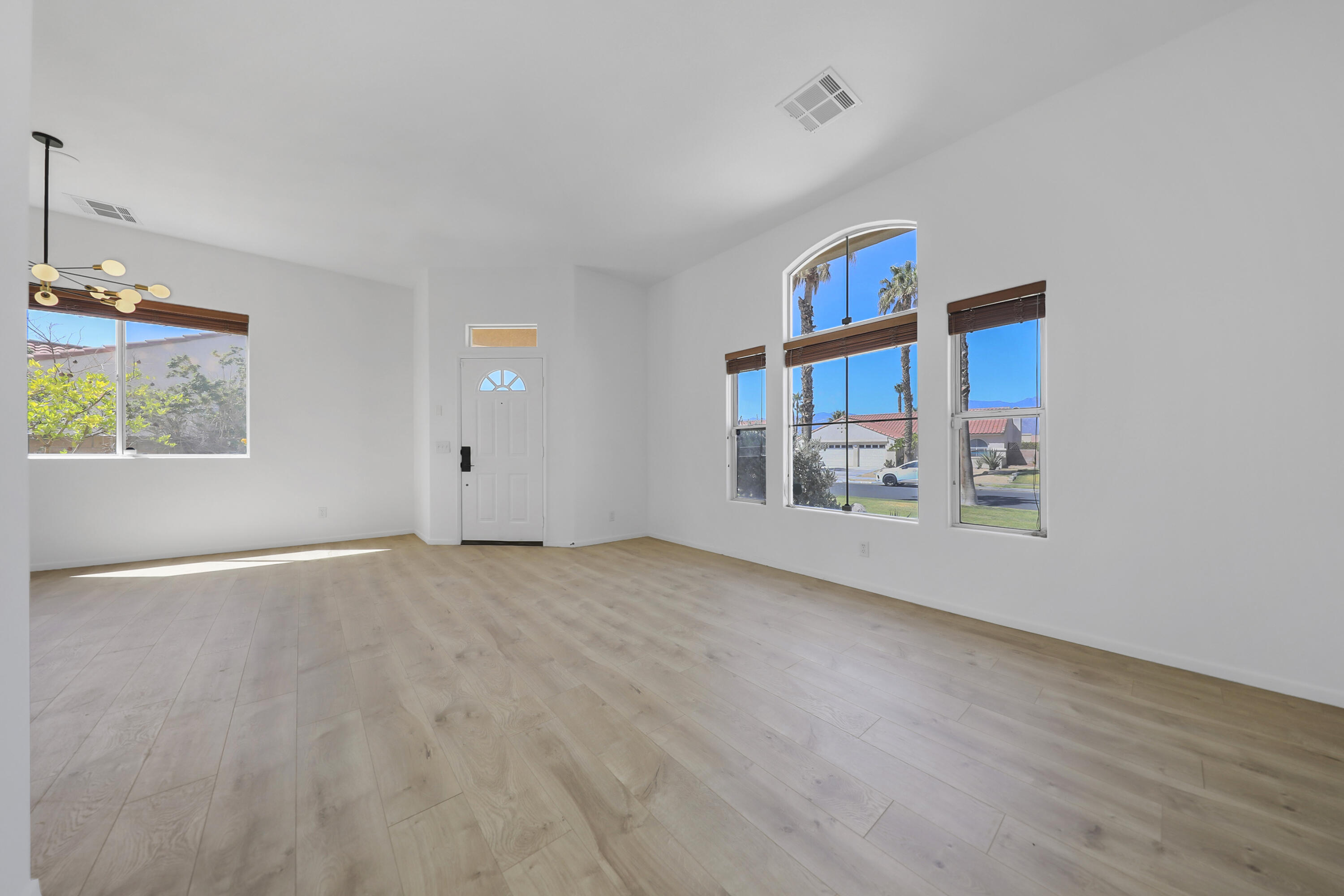 68256 Pasada Road Cathedral City, CA 92234 - Photo 4 of 35 a view of an empty room with window and hardwood floor