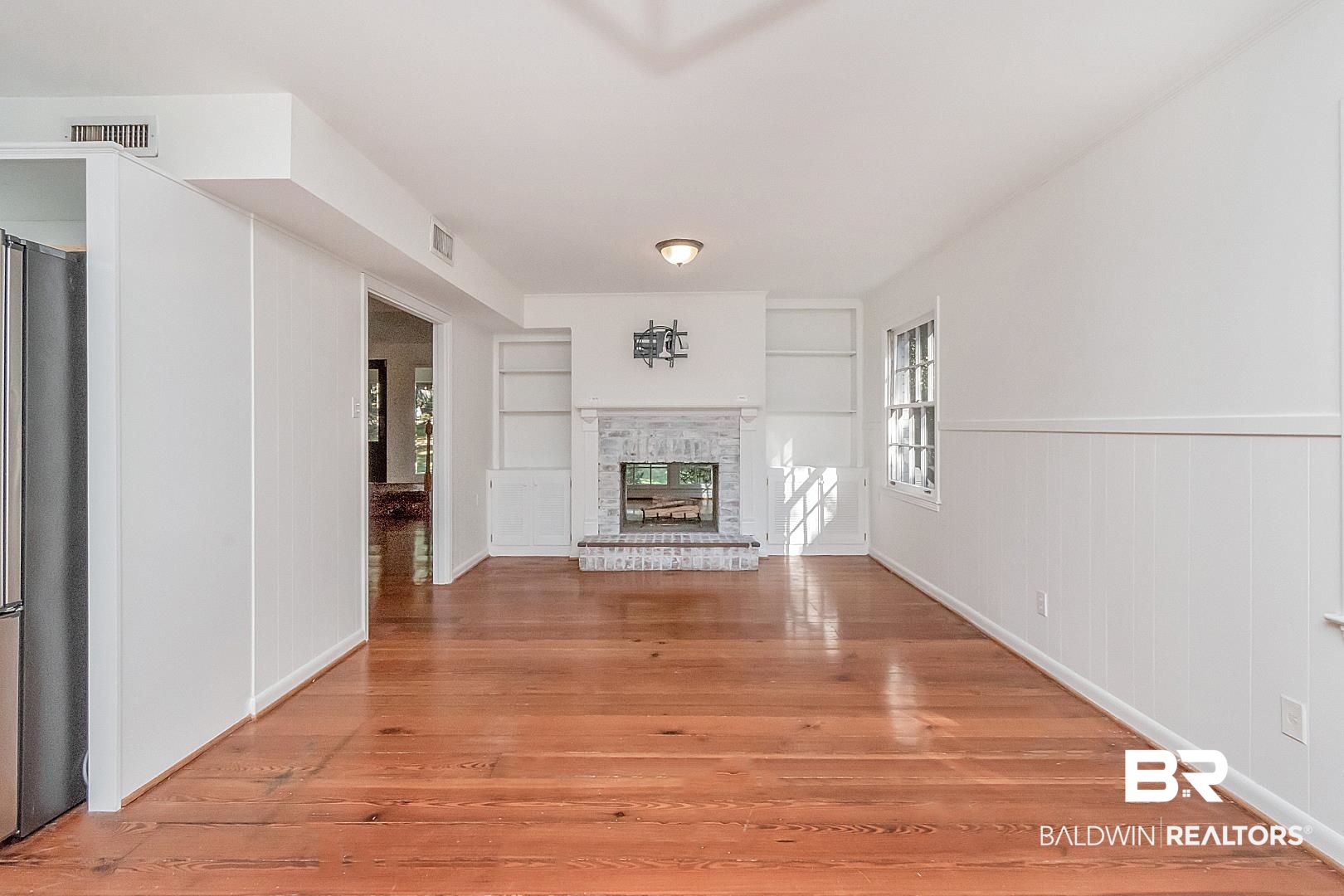 117 Ridgelawn Drive West Mobile, AL 36608 - Photo 9 of 31 Built in shelves, dual sided fireplace, lots of natural light, beautiful wide plank pinewood floors, dual sided fireplace.