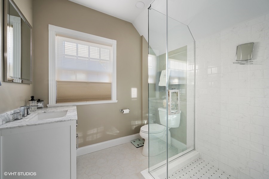 375 Sterling Road Kenilworth, IL 60043 - Photo 18 of 28 a bathroom with a granite countertop sink a toilet and shower
