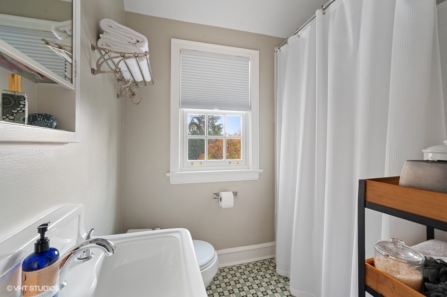 375 Sterling Road Kenilworth, IL 60043 - Photo 25 of 28 a bathroom with a sink and a shower curtain