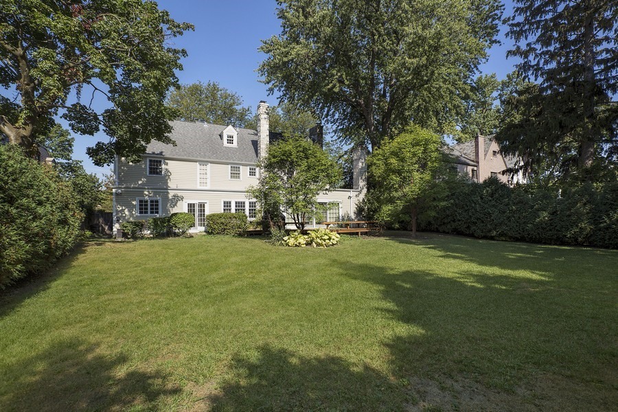 375 Sterling Road Kenilworth, IL 60043 - Photo 27 of 28 a view of a big house with a big yard and large trees