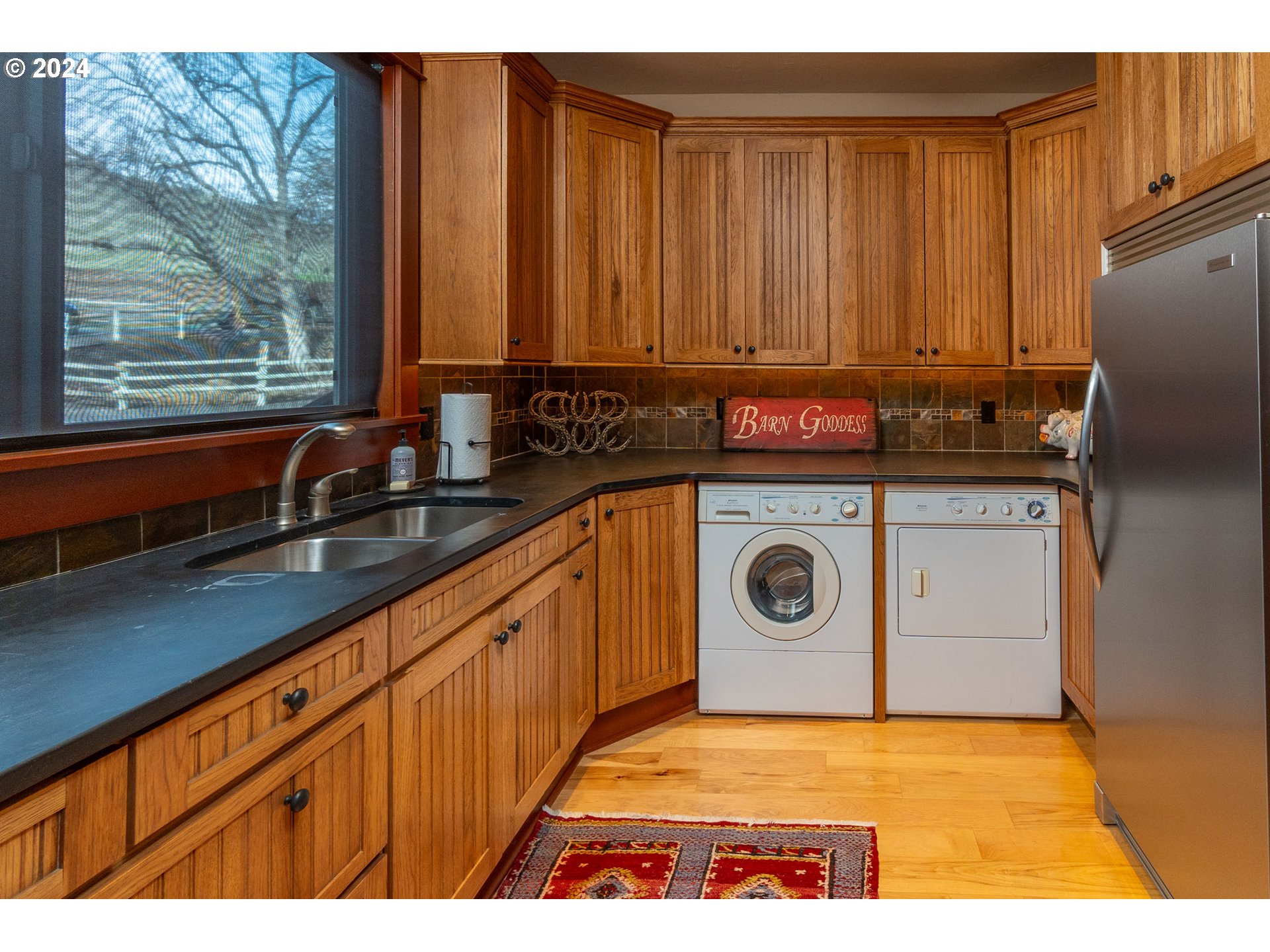 6100 Eightmile Road The Dalles, OR 97058 - Photo 16 of 44 a view of a kitchen with wooden floor washer and dryer