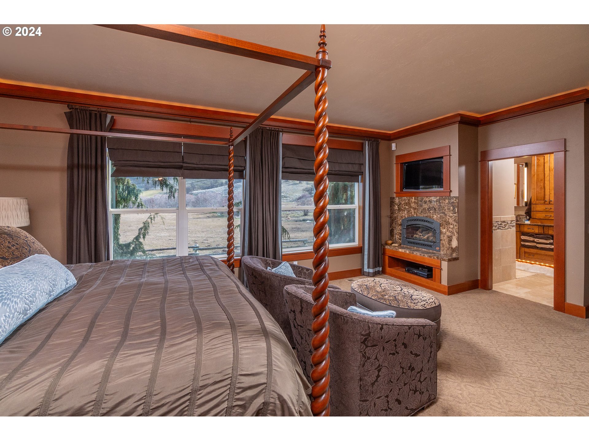 6100 Eightmile Road The Dalles, OR 97058 - Photo 17 of 44 a bedroom with a bed and large windows