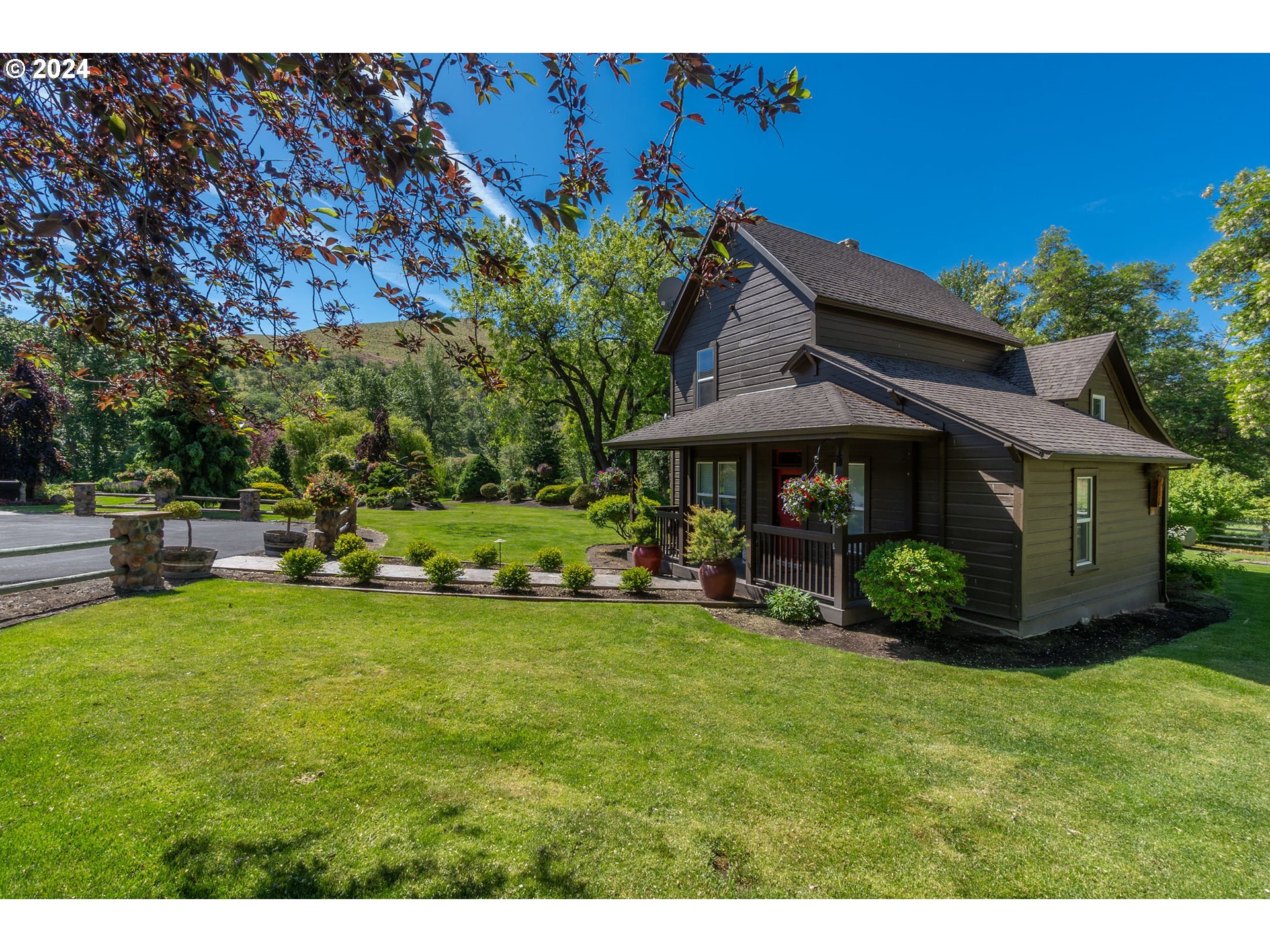 6100 Eightmile Road The Dalles, OR 97058 - Photo 26 of 44 a view of a house with backyard sitting area and garden