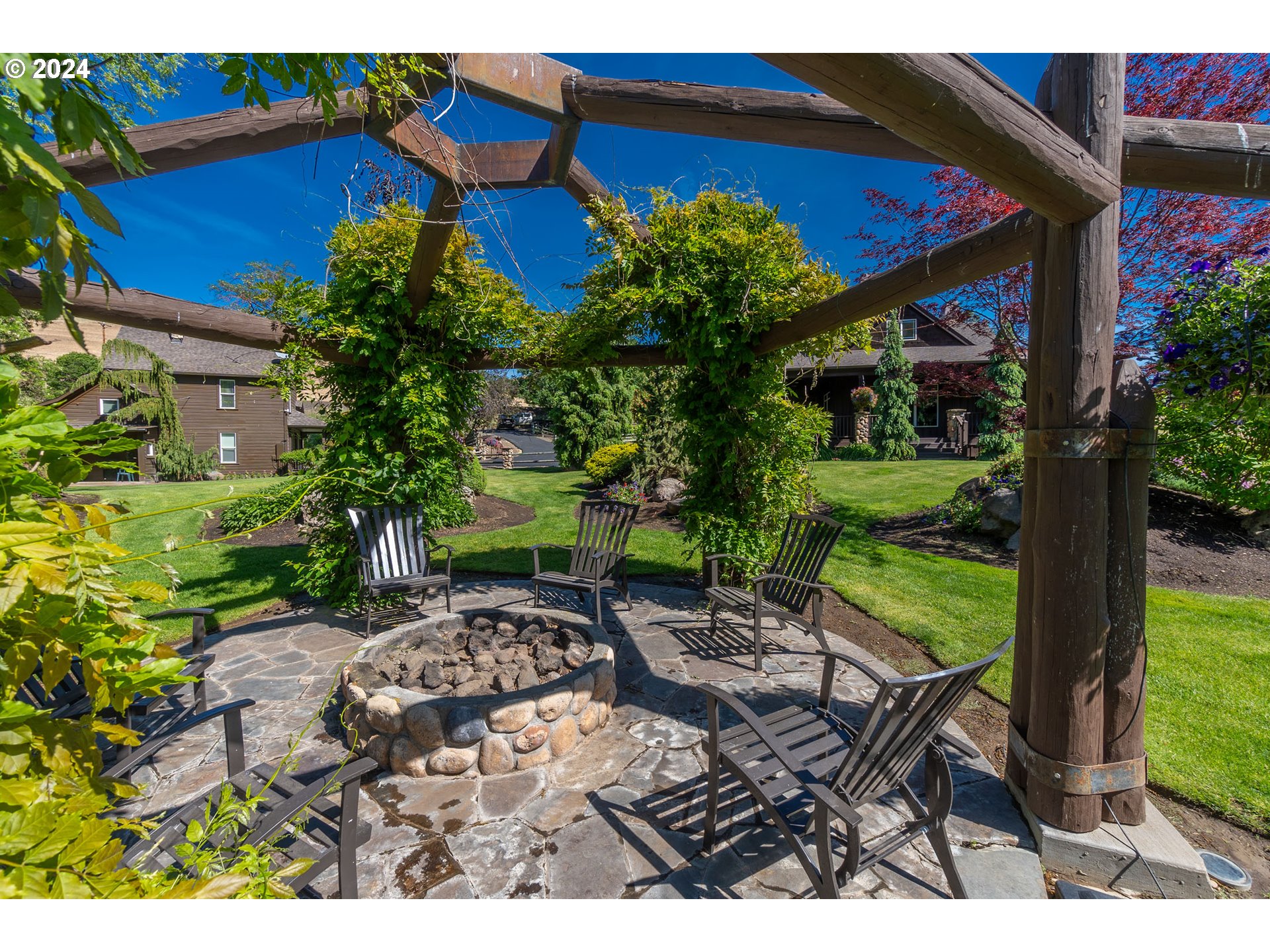6100 Eightmile Road The Dalles, OR 97058 - Photo 39 of 44 a view of a chairs and table in a backyard