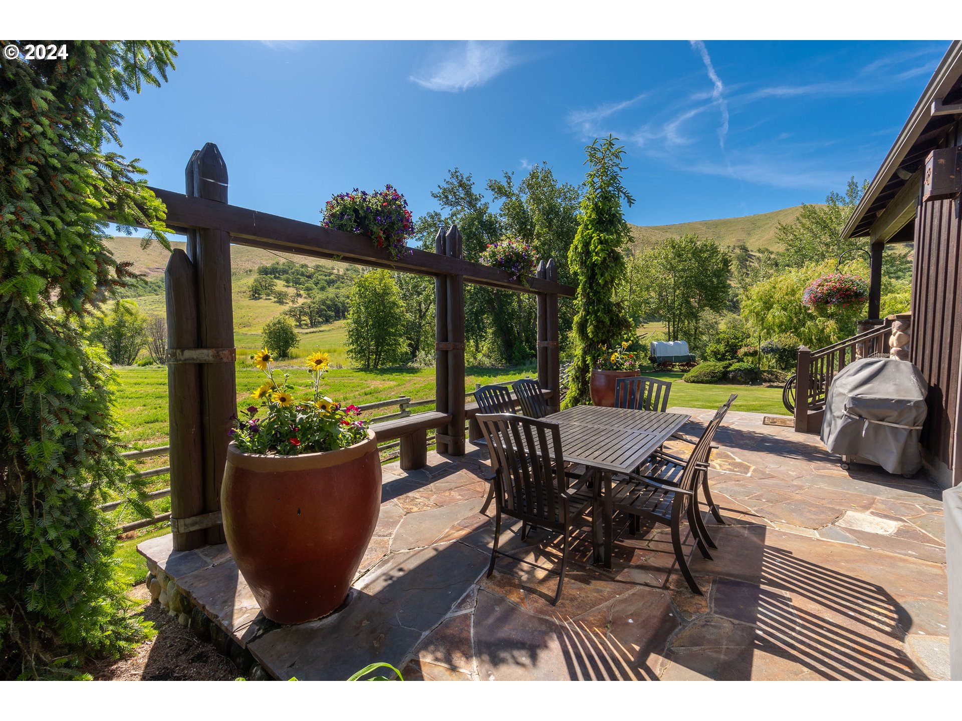 6100 Eightmile Road The Dalles, OR 97058 - Photo 8 of 44 a view of a dining table and chairs in the patio