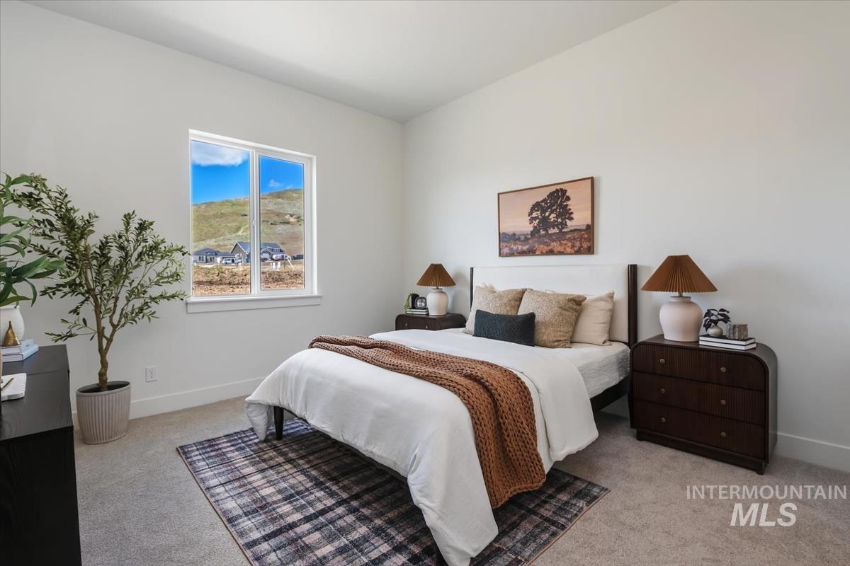 7615 Brown Way Eagle, ID 83714 - Photo 33 of 43 Bedroom featuring a large double window, white walls, light gray carpet, and white baseboards