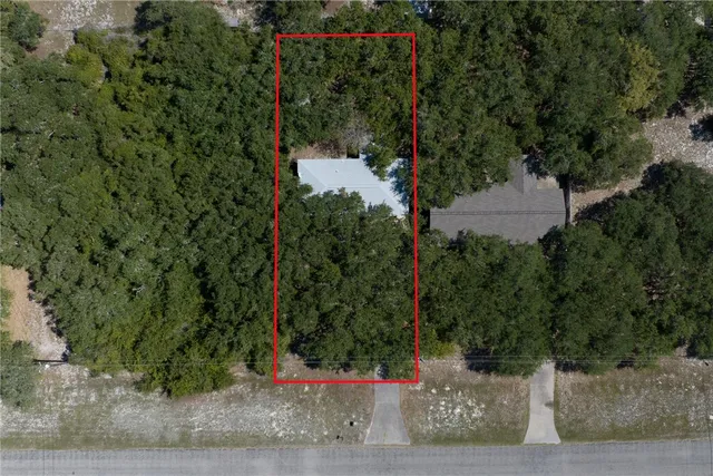 a swimming pool with trees in front of it