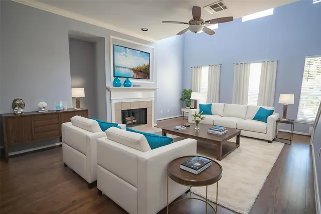 a living room with furniture a fireplace and a flat screen tv